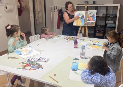 Profesora con niños en clase de dibujo y pintura